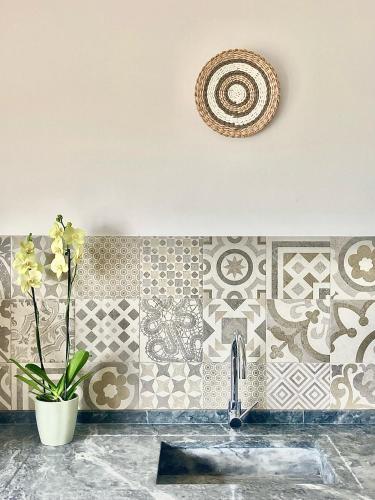 a kitchen with a sink and tiles on the wall at The Globetrotter's Inn in Ericeira