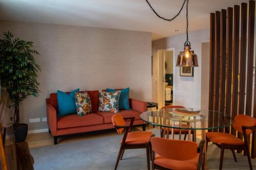 a living room with a couch and a glass table at Casas do Porto - Ribeira Apartments in Porto