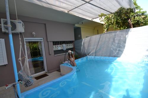 a person in an indoor swimming pool with a water slide at Paradise House with Private Pool in Kissamos