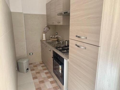 a small kitchen with a stove and a sink at Civico35 in San Vito dei Normanni