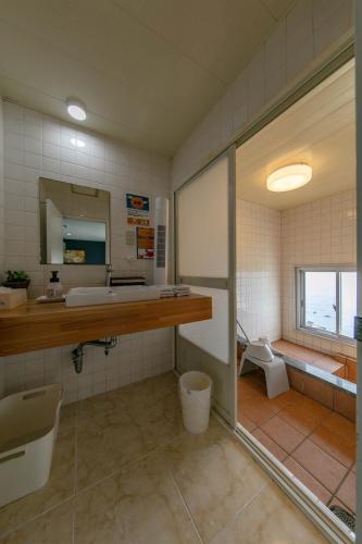 a bathroom with a toilet and a sink and a mirror at Villa BluMare Shirahama in Shirahama