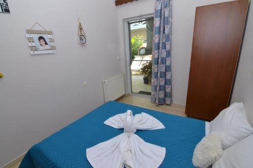 a bedroom with a blue bed with a bow on it at Paradise House with Private Pool in Kissamos