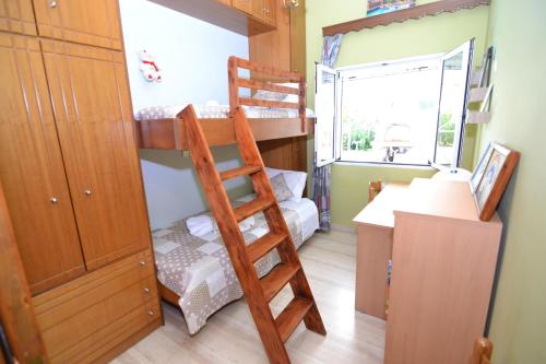 a bedroom with two bunk beds and a desk at Paradise House with Private Pool in Kissamos