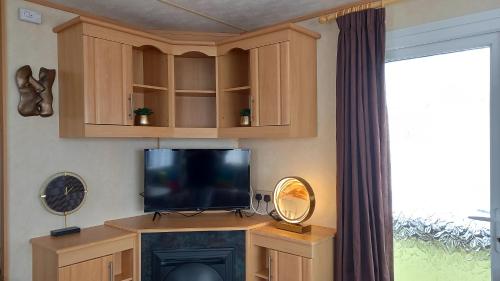 a living room with a tv and a fireplace at A&P Sheron Holiday Home - The Chase, Ingoldmells, Skegness in Ingoldmells
