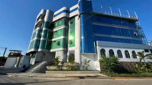a blue and green building with stairs in front of it at Rio Cumbaza Hotel in Tarapoto