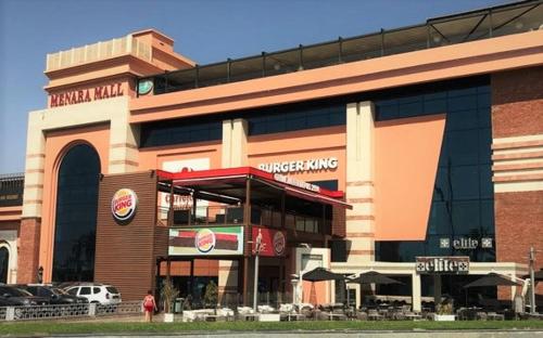 a fast food building with a car parked in front of it at Royal Deluxe Silver - Marrakech, Luxe Pool View in Marrakech