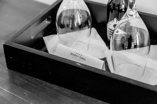 a black box with two wine glasses on a counter at International Bucharest City Centre Hotel in Bucharest