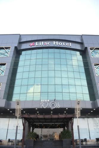 a large building with a like hotel sign on it at Lilac Hotel in Erbil