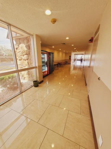 an empty hallway with a large window in a building at Ramada by Wyndham Grand Junction in Grand Junction