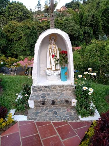 a statue of a goddess in a garden at Lago Calima - Bella Finca in Madroñal