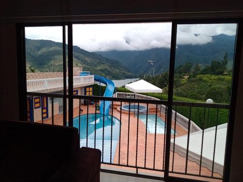 a view of a swimming pool from a balcony at Lago Calima - Bella Finca in Madroñal