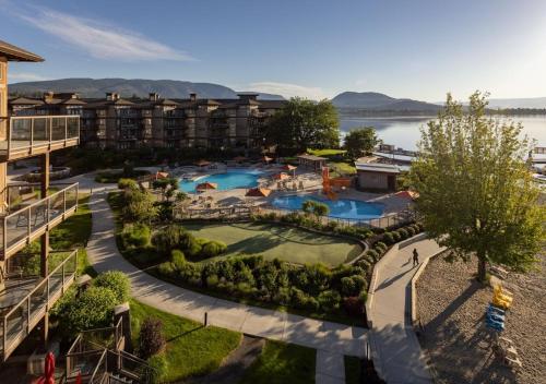 an aerial view of a resort with two pools at The Cove Lakeside Resort in West Kelowna