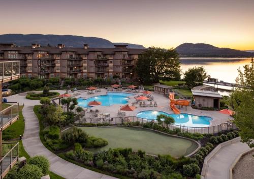 an aerial view of a resort with two pools at The Cove Lakeside Resort in West Kelowna