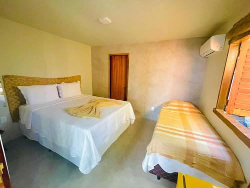 Llit o llits en una habitació de Pousada Jaboticaba Caraíva