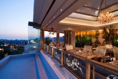 a restaurant on the balcony of a building at The Athenian Callirhoe Exclusive Hotel in Athens