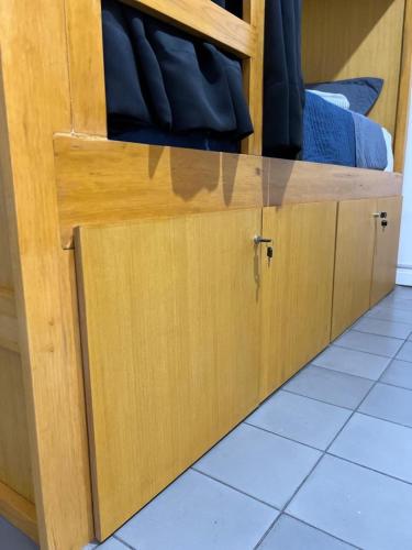 a wooden cabinet with a drawer in a room at Leveli Coliving in Guadalajara