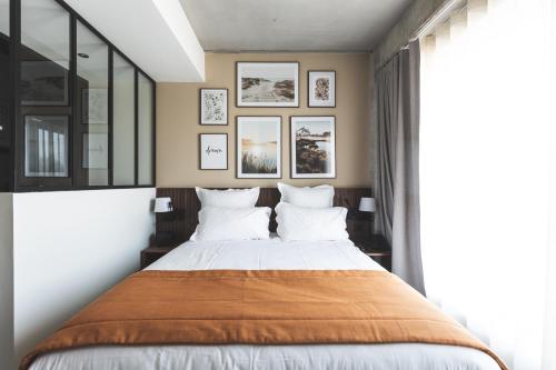a bedroom with a large bed and a large window at Coloft in Lesquin