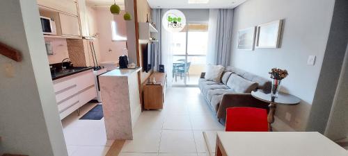 a kitchen and a living room with a couch and a table at COSTE0100 - Residencial Luz das Acácias in Salvador