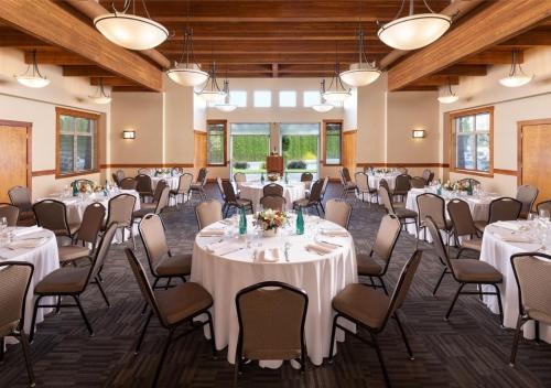 a banquet hall with tables and chairs in a room at The Cove Lakeside Resort in West Kelowna