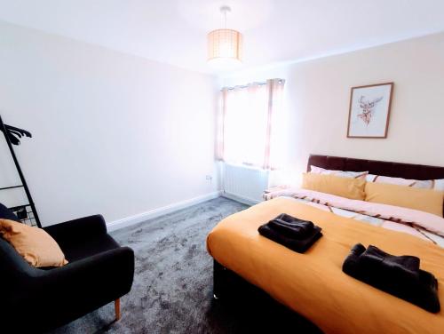 a bedroom with a large bed and a chair at Crystal Suite 3 Free Private Parking in South Shields
