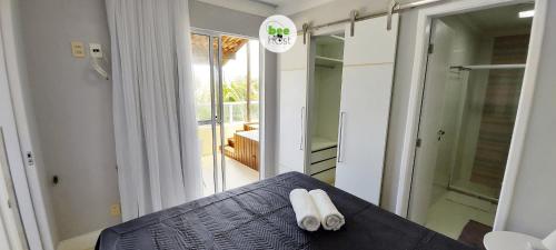 a room with a bed with two towels on it at COSTE0100 - Residencial Luz das Acácias in Salvador