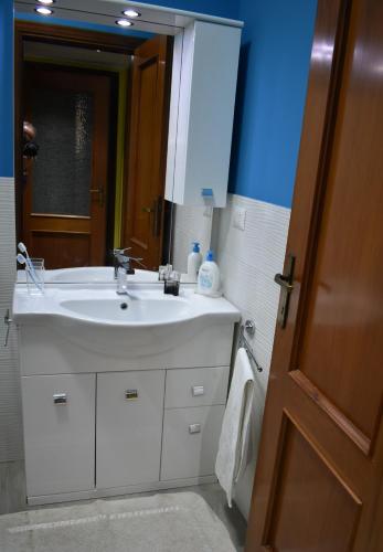 a bathroom with a white sink and a mirror at La casa di Antonio in Briatico