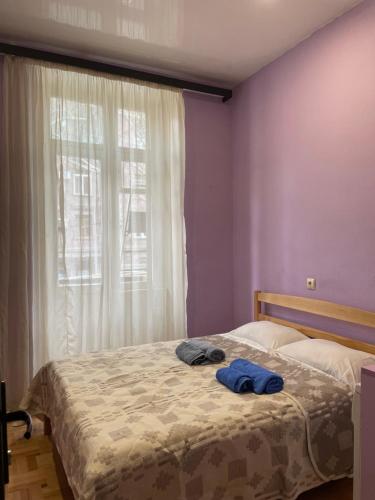 a bedroom with a bed with two towels on it at Cozy Apartment on Republic Square in Yerevan