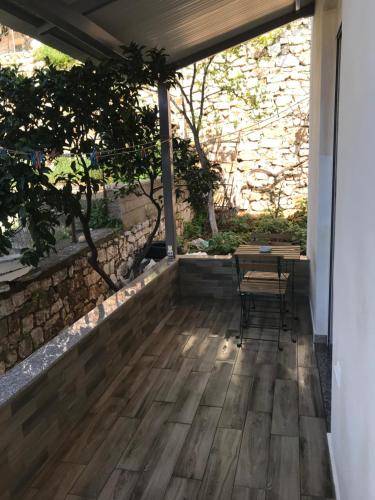 a patio with a table and chairs on it at Elti Apartment in Sarandë