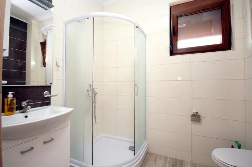 een badkamer met een douche en een wastafel bij Apartments Md Lux in Sutomore