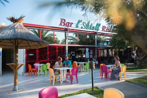 personnes assises à table devant un restaurant dans l'établissement La Carabasse Vias Plage Mobile Home 8 personnes, à Vias
