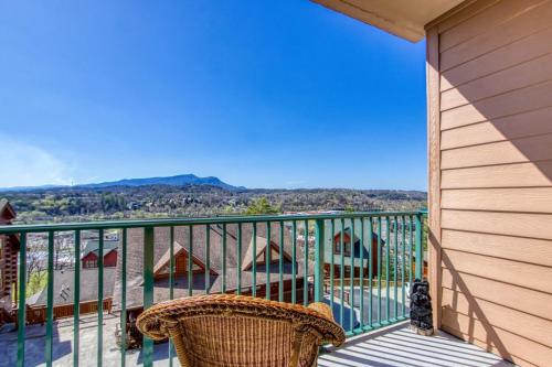a balcony with a chair and a view of the mountains at Gorgeous 2BD 2BTH Condo with Mountain Views Pool Hot Tub Game Room Close to Parkway in Pigeon Forge