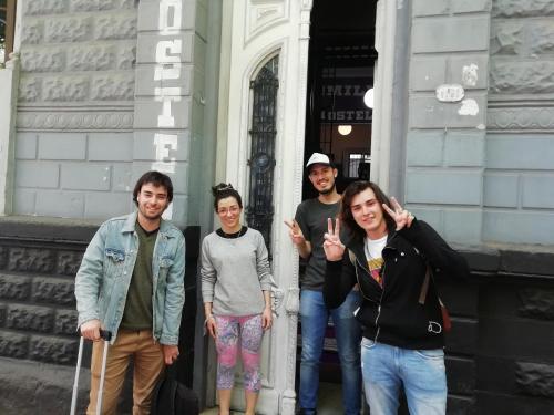 a group of people standing outside of a building at Windmill Hostel in Mendoza