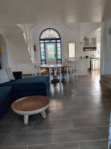 a living room with a blue couch and a table at 44 Montego Bay Caribbean Estates in Port Edward