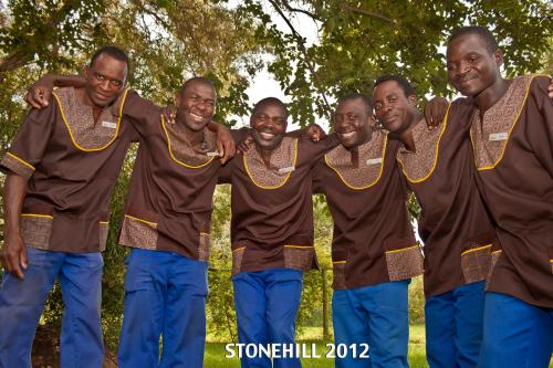 a group of men in brown shirts posing for a picture at Stone Hill in Magaliesburg