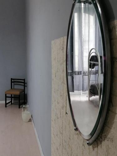 a mirror hanging on a wall in a room at Sahary in Naples