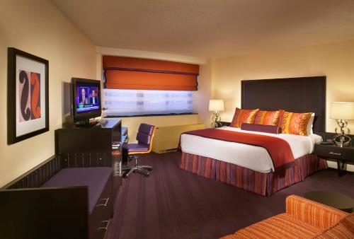 a hotel room with a large bed and a television at Washington Plaza Hotel in Washington, D.C.