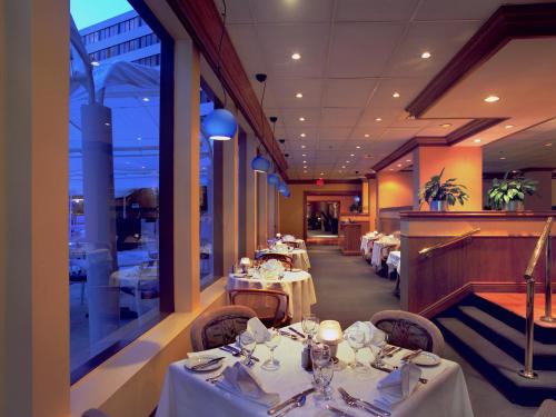 a dining room with tables with white tablecloths at Washington Plaza Hotel in Washington