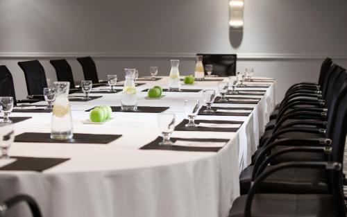a row of tables in a room with white table cloth at Washington Plaza Hotel in Washington
