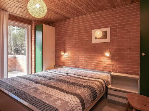 a bedroom with a brick wall and a bed at 6 person holiday home in Hurup Thy-By Traum in Sindrup