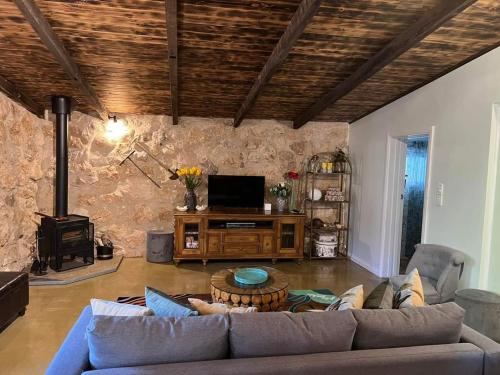 a living room with a couch and a table at Maunder Cottage Aldinga Township in Aldinga