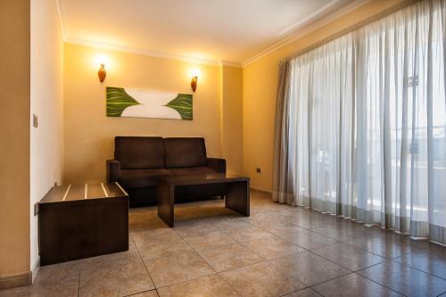 a living room with a couch and a window at Kn Aparthotel Columbus in Playa de las Americas