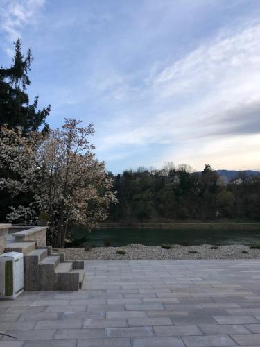 a stone walkway with stairs next to a lake at Maximo Apartments - free parking in Maribor