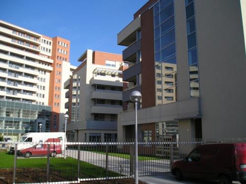 a van parked in a parking lot next to buildings at Apartament przy Rynku in Poznań