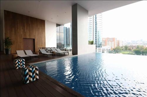 a swimming pool with a view of a building at KL Sentral Serviced Apartment - The Establishment KL Sentral by Loop Suites in Kuala Lumpur