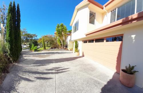 a driveway leading to a house with a garage at Seascape Villa B&B in Tauranga