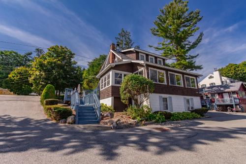 a house with a staircase in front of it at Cramers Point Lake Breeze in Lake George