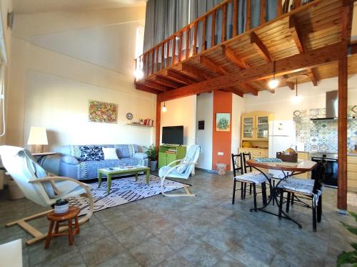 a living room with a couch and a table and chairs at Villa Loula google it in Lygia