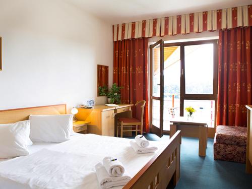 Postel nebo postele na pokoji v ubytování K-Triumf Resort