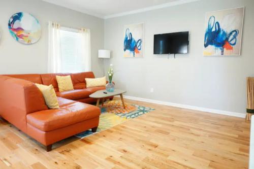 a living room with a couch and a tv at Atlanta Unit 1 Room 1 - Peaceful Private Master Bedroom Suite with Private Balcony in Atlanta