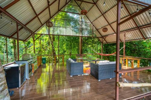 a screened in porch of a house with trees at Drake Bay River View in Drake
